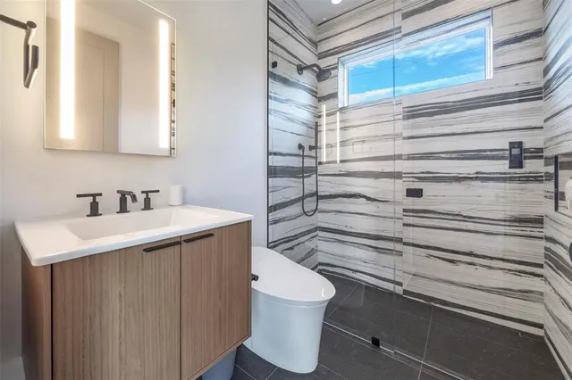 a bathroom with a sink toilet and shower