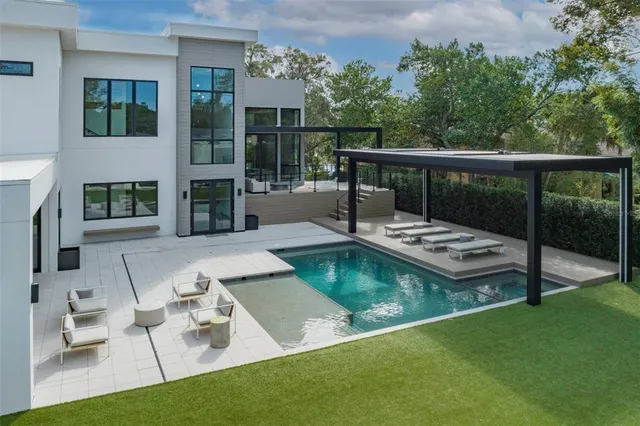 a view of a house with swimming pool and porch