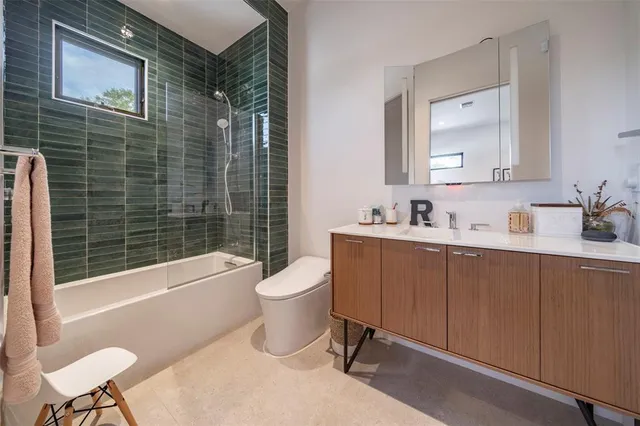 a bathroom with a sink mirror toilet and bathtub