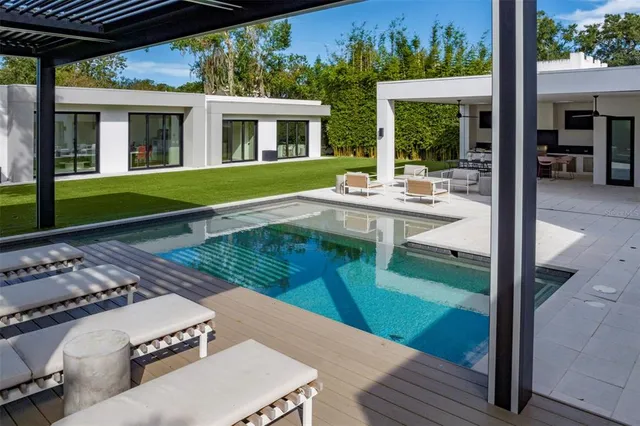 a view of a house with backyard porch and sitting area