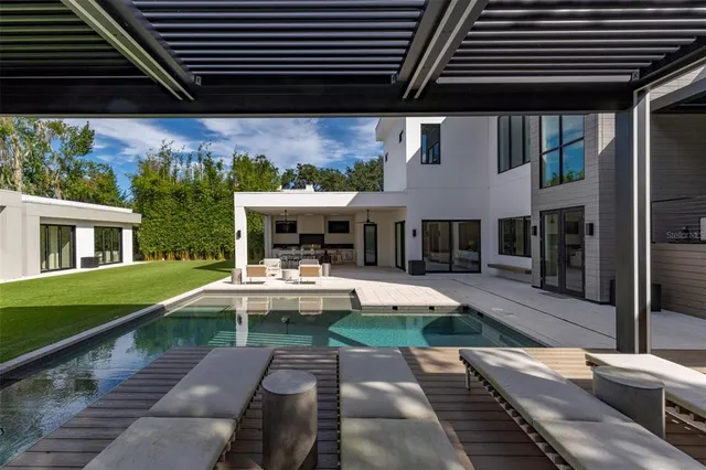 a view of a house with backyard porch and sitting area