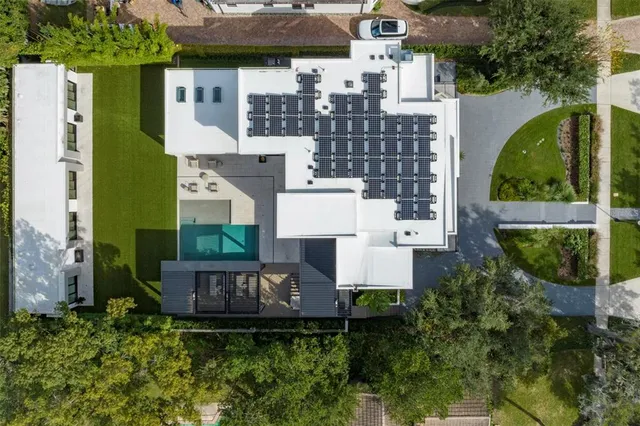an aerial view of a house with a yard