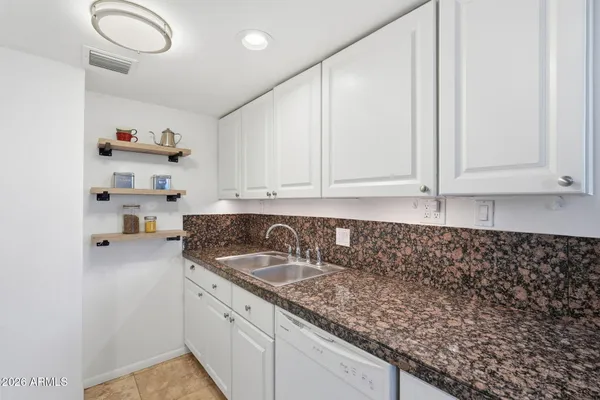 a kitchen with a sink and cabinets