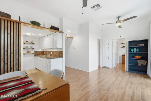 a living room with furniture and view kitchen