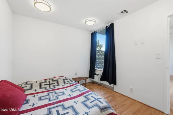 a bedroom with a bed and a window