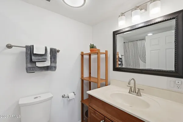 a bathroom with a sink vanity and mirror