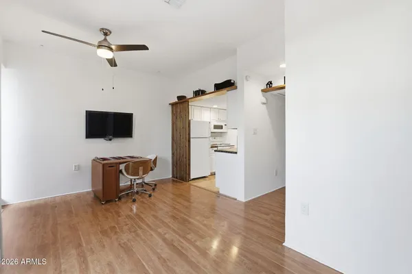a view of a workspace with furniture and wooden floor