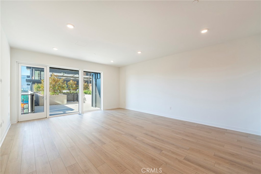 3211 Rivington Irvine, CA 92612 - Photo 11 of 49 a view of an empty room with wooden floor and a window