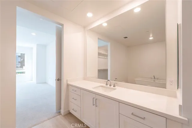 a spacious bathroom with a double vanity sink and a mirror