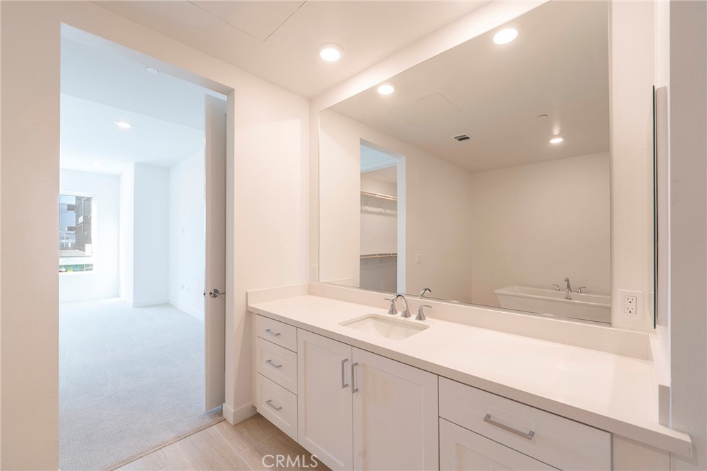 3211 Rivington Irvine, CA 92612 - Photo 19 of 49 a spacious bathroom with a double vanity sink and a mirror