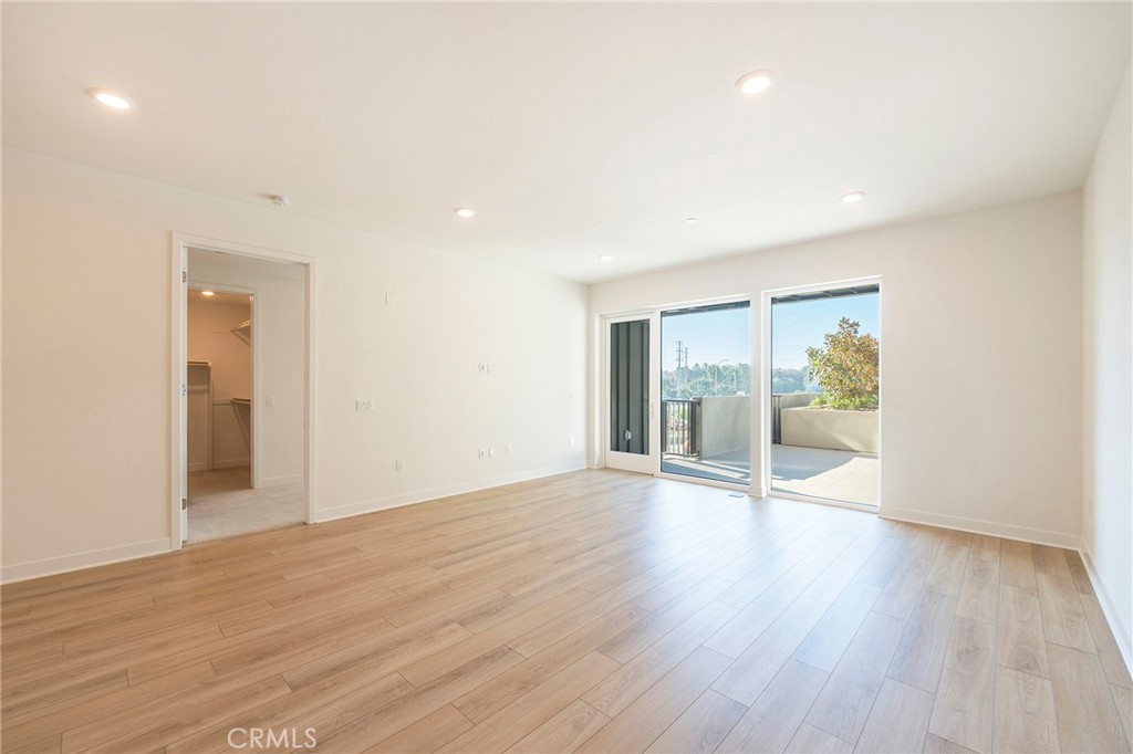 3211 Rivington Irvine, CA 92612 - Photo 2 of 49 a view of an empty room with wooden floor and a window