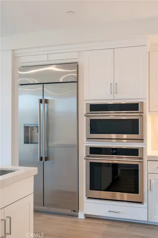 a stove top oven sitting inside of a kitchen