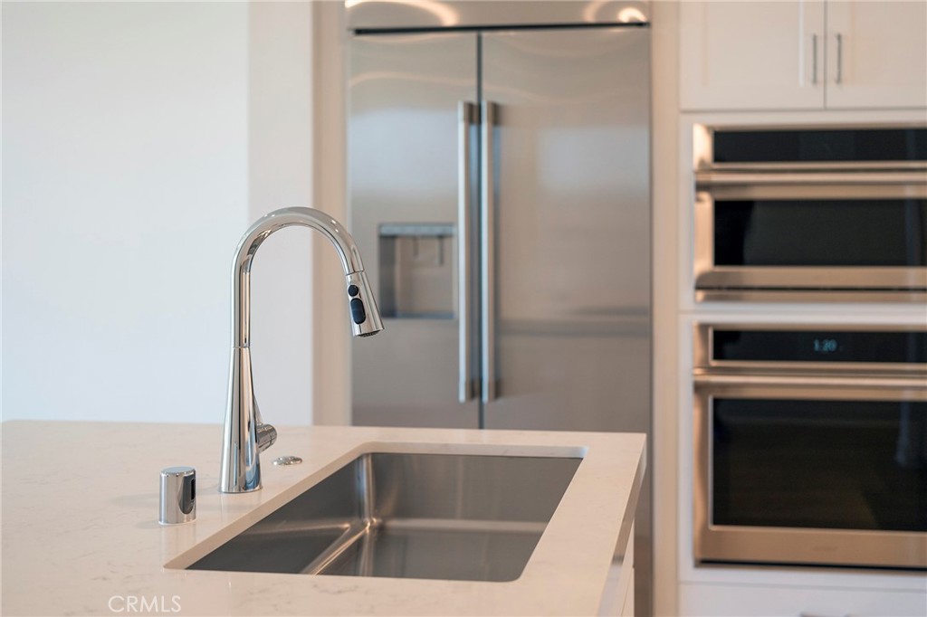 3211 Rivington Irvine, CA 92612 - Photo 27 of 49 a close view of a sink and a stove in a kitchen