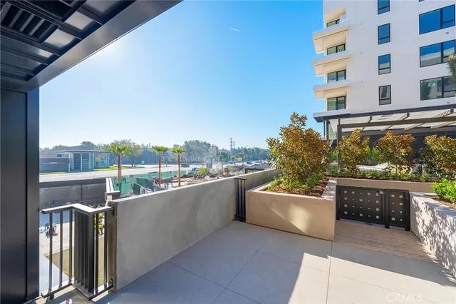 a view of a roof deck with couches and potted plants