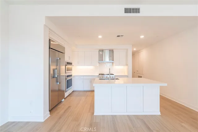 a kitchen with stainless steel appliances a white stove top oven and a refrigerator