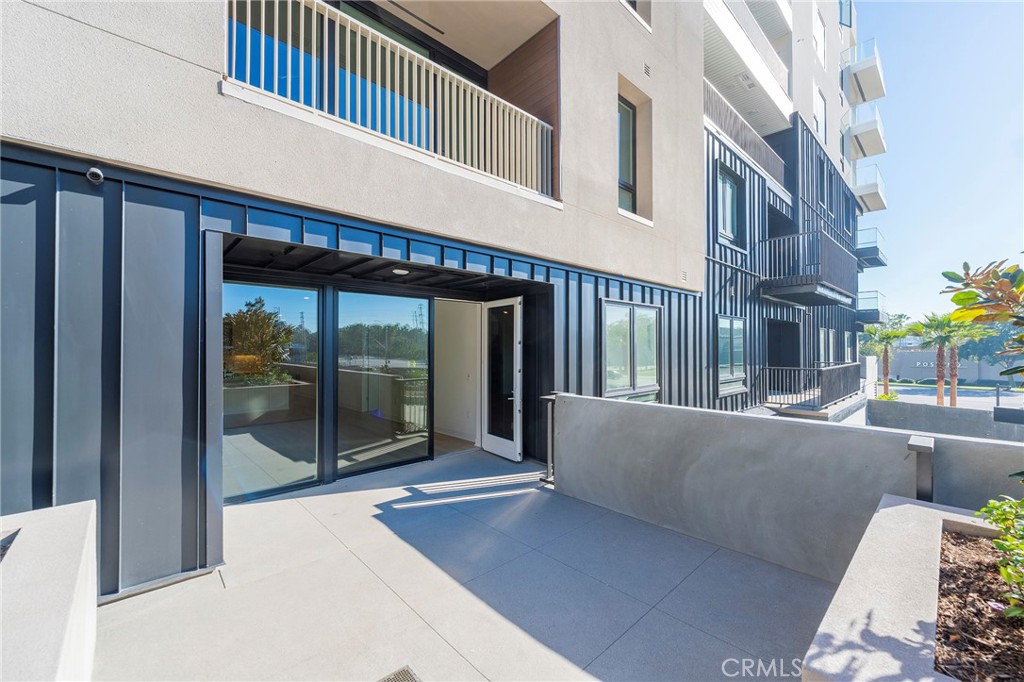 3211 Rivington Irvine, CA 92612 - Photo 32 of 49 a view of a building with a potted plant and floor to ceiling windows