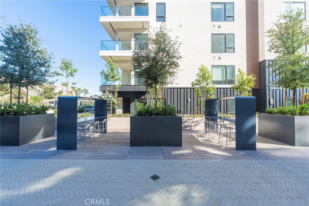 3211 Rivington Irvine, CA 92612 - Photo 35 of 49 a view of a building with floor to ceiling windows and wooden fence
