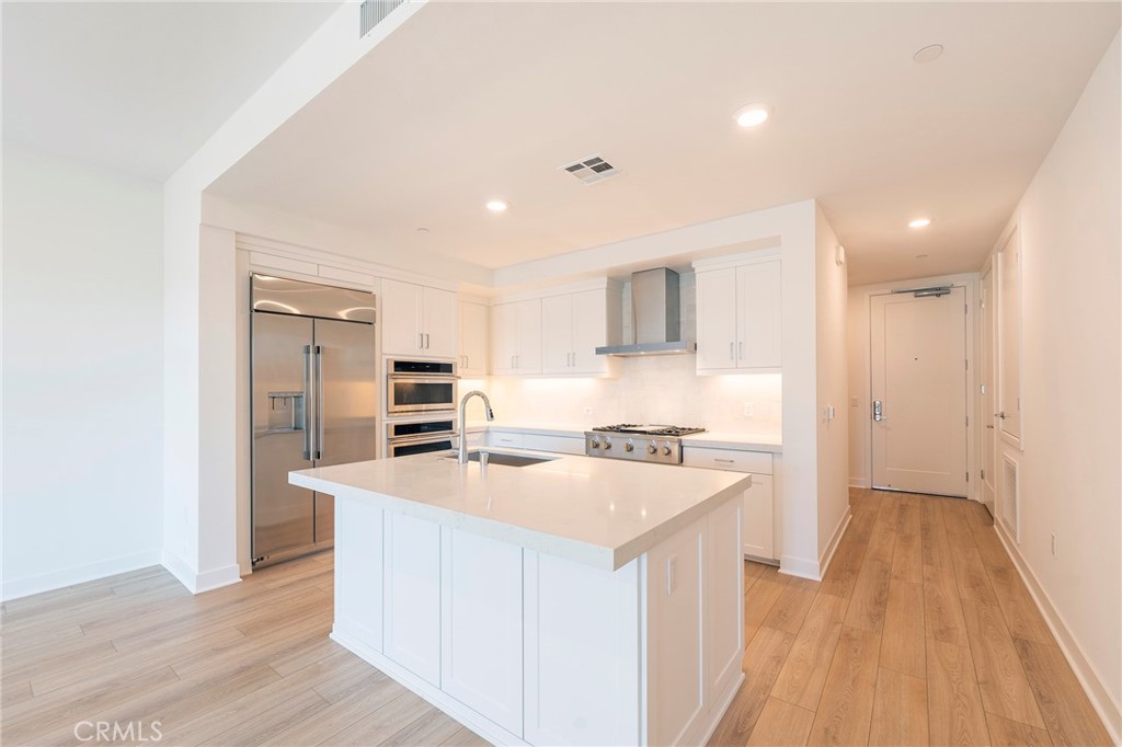 3211 Rivington Irvine, CA 92612 - Photo 4 of 49 a kitchen with a stove a sink and a refrigerator