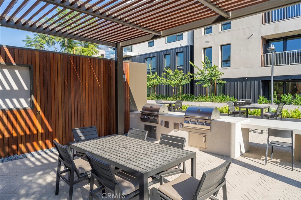 3211 Rivington Irvine, CA 92612 - Photo 43 of 49 a view of a patio with table and chairs potted plants and wooden fence