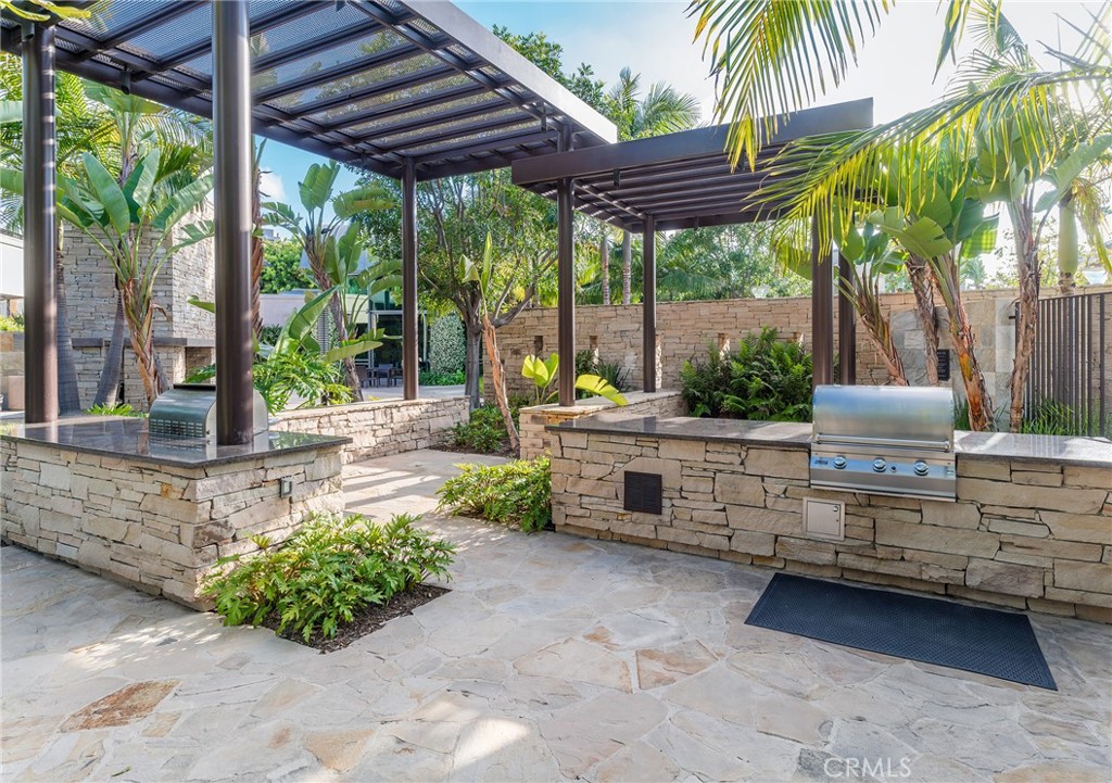 3211 Rivington Irvine, CA 92612 - Photo 49 of 49 a view of a patio with table and chairs potted plants and large tree