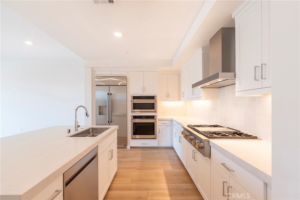 3211 Rivington Irvine, CA 92612 - Photo 5 of 49 a kitchen with kitchen island stainless steel appliances a sink stove and refrigerator