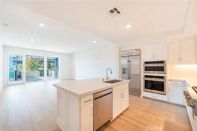a kitchen with a stove a sink and a refrigerator