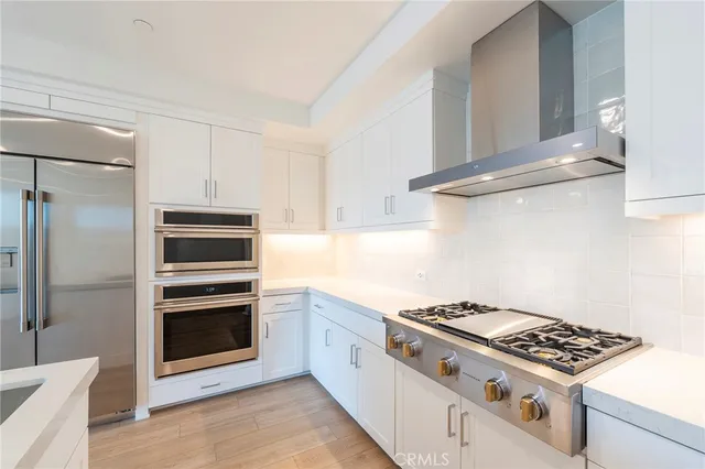 a white stove top oven sitting inside of a kitchen