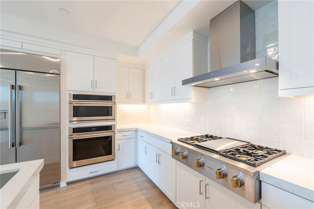3211 Rivington Irvine, CA 92612 - Photo 7 of 49 a white stove top oven sitting inside of a kitchen