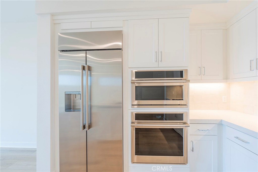 3211 Rivington Irvine, CA 92612 - Photo 8 of 49 a kitchen with cabinets and stainless steel appliances