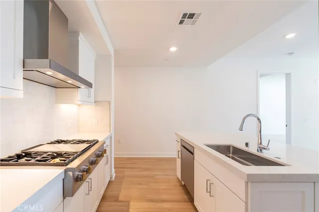 a kitchen with a stove and a sink