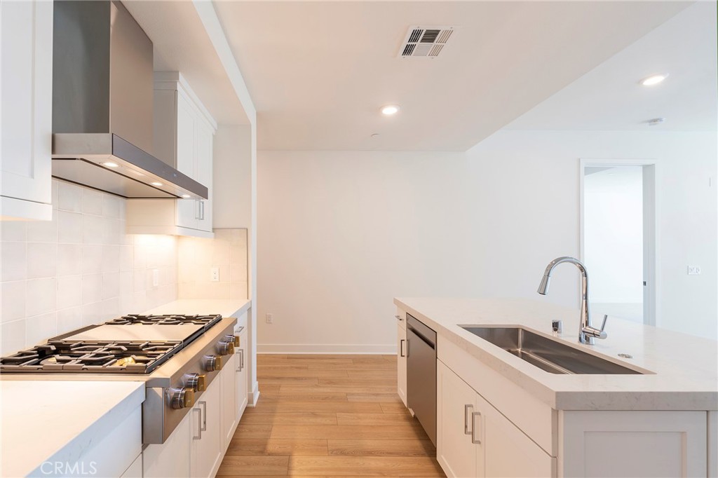 3211 Rivington Irvine, CA 92612 - Photo 9 of 49 a kitchen with a stove and a sink