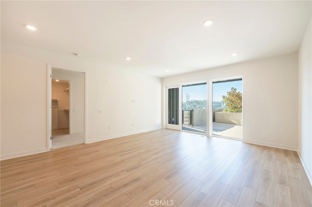 3211 Rivington Irvine, CA 92612 - Photo 10 of 49 a view of an empty room with wooden floor and a window