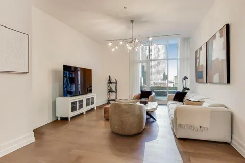 a bedroom with a bed and a chandelier