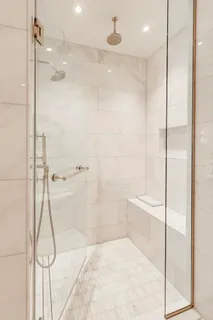 a spacious bedroom with a bed a table and chairs