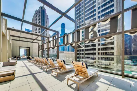 a living room with furniture a clock and a chandelier
