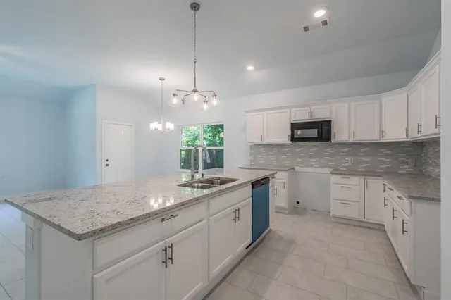 a kitchen with a sink stove and microwave