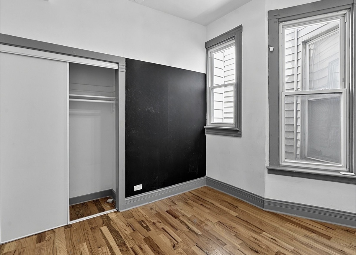 6602 South Marquette Road Chicago, IL 60637 - Photo 11 of 24 a view of an empty room with wooden floor and a window