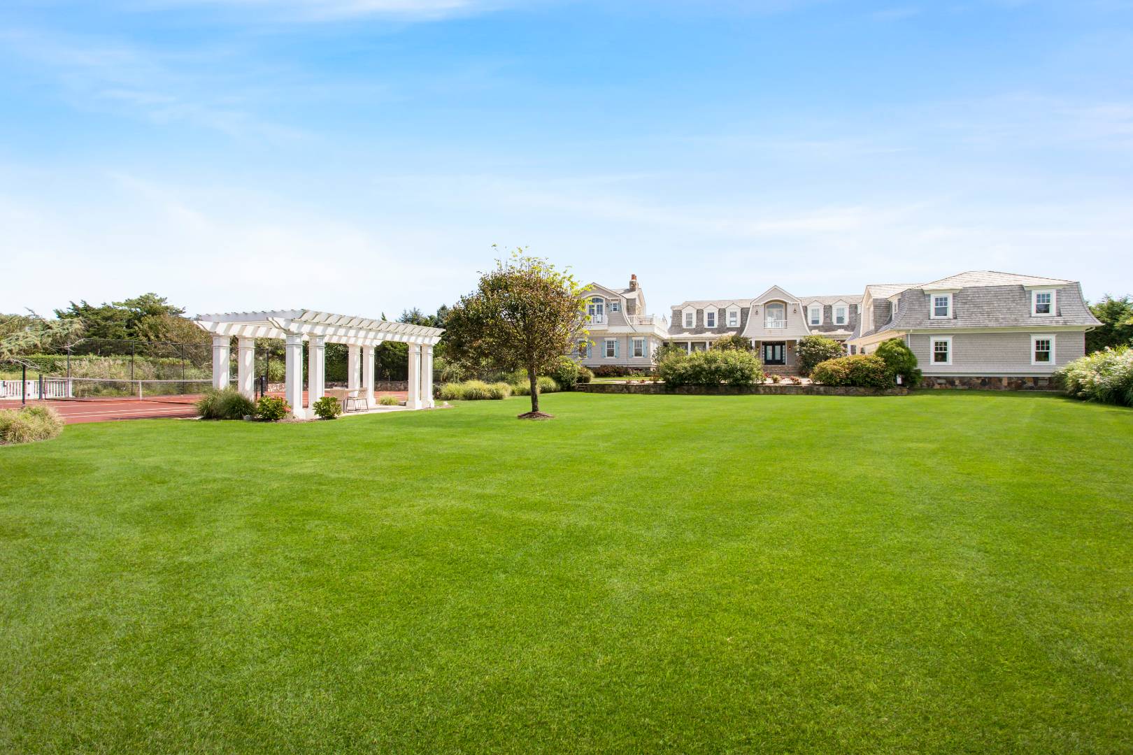 124 Dune Road Quogue, NY 11959 - Photo 2 of 34 a view of a house with a big yard