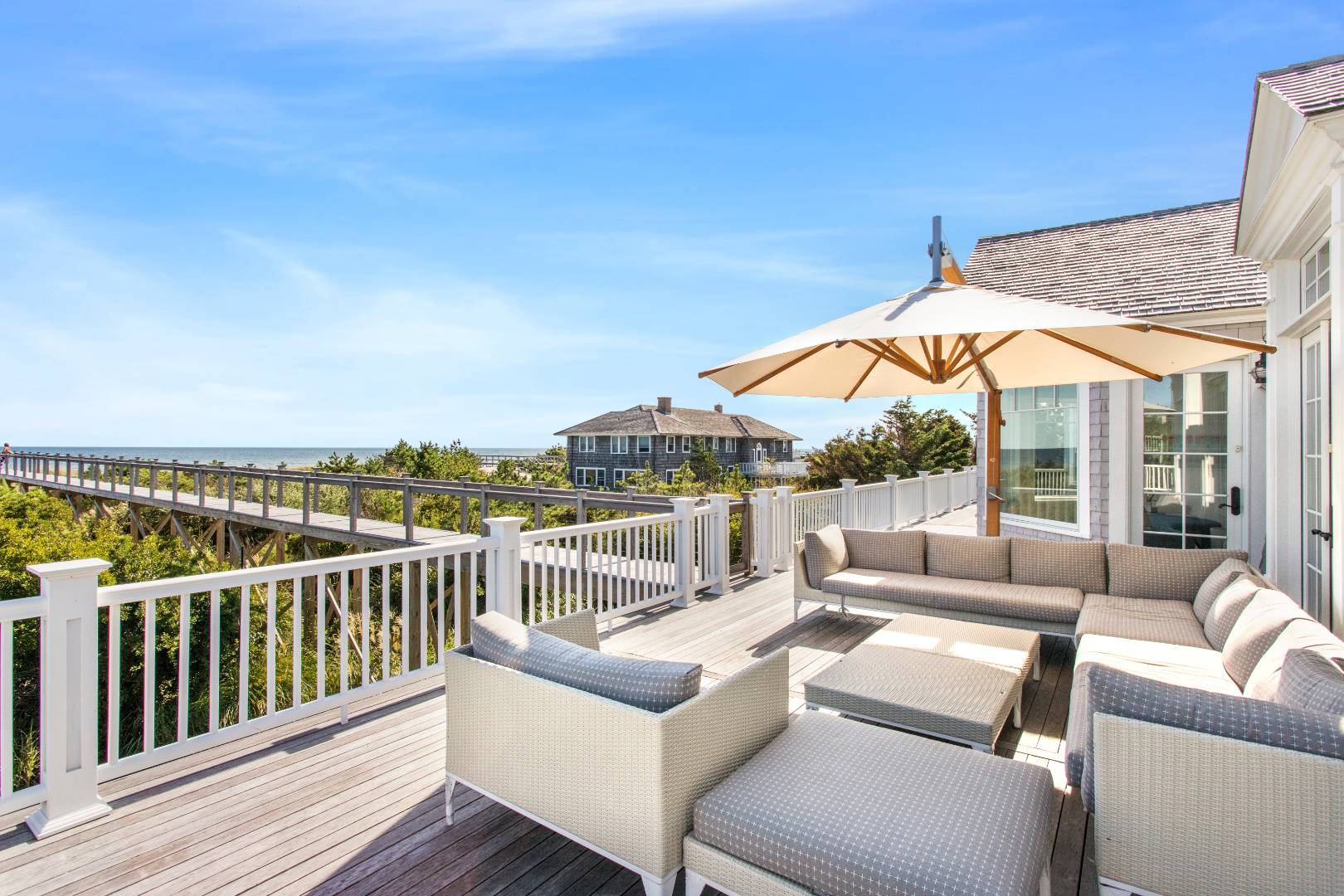 124 Dune Road Quogue, NY 11959 - Photo 24 of 34 a view of roof deck with couches and city view