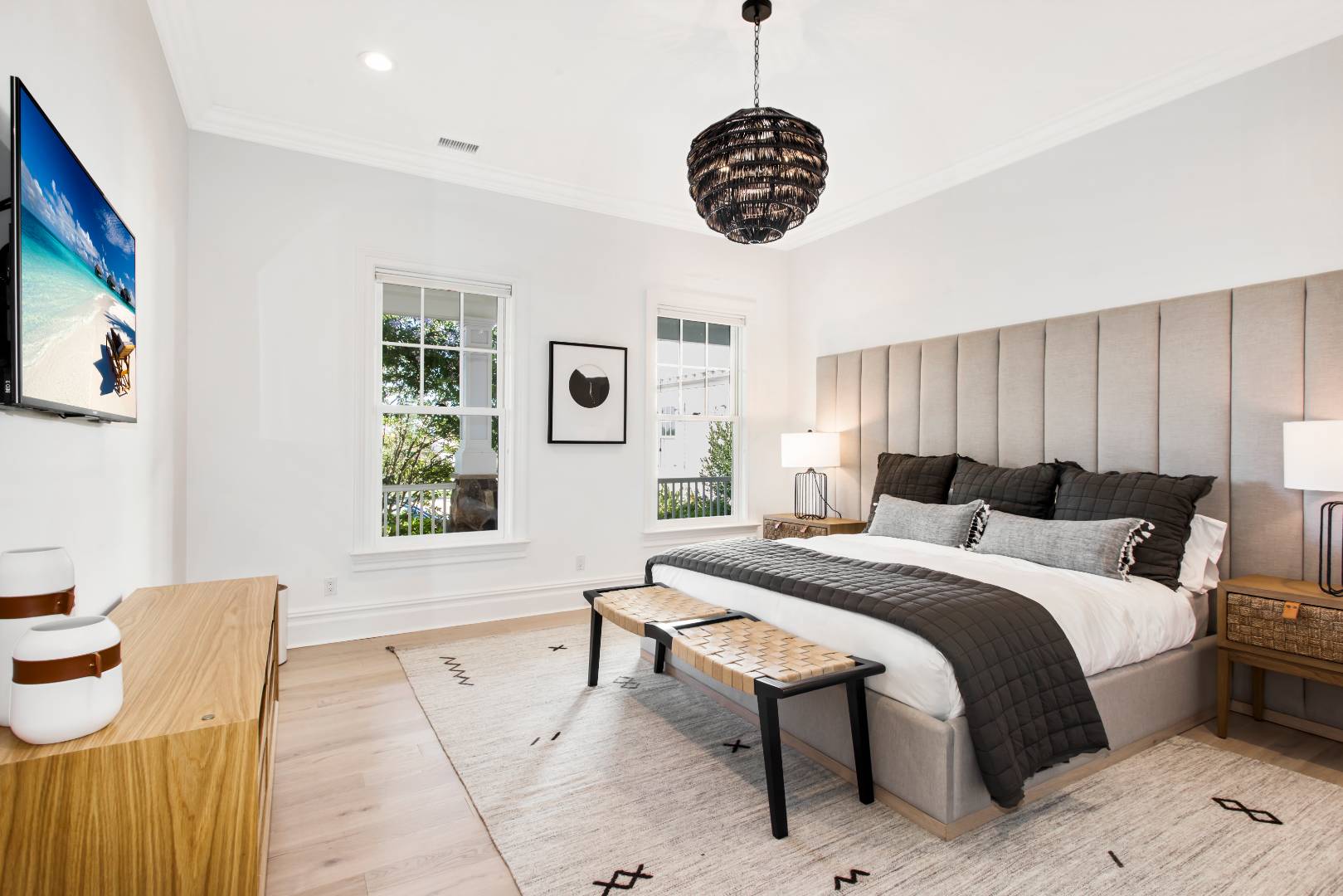 124 Dune Road Quogue, NY 11959 - Photo 26 of 34 a bed room with a bed and a chandelier