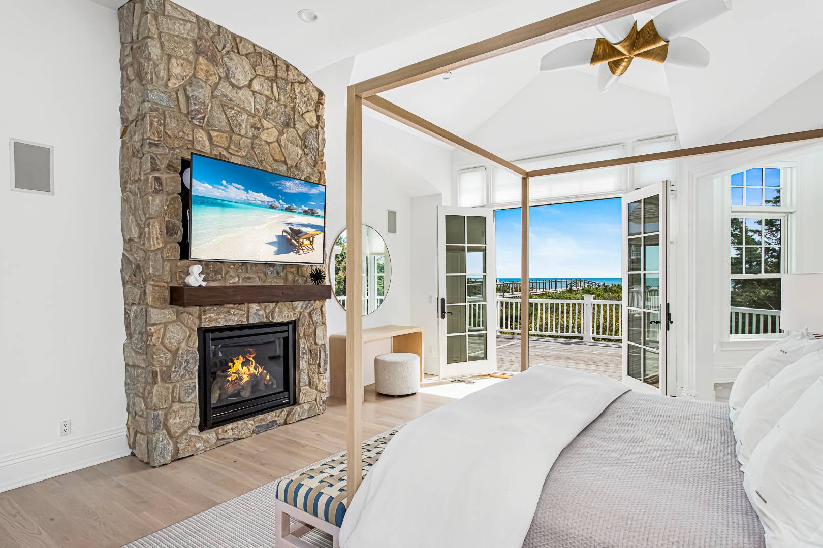 124 Dune Road Quogue, NY 11959 - Photo 29 of 34 a bedroom with a bed and a fireplace