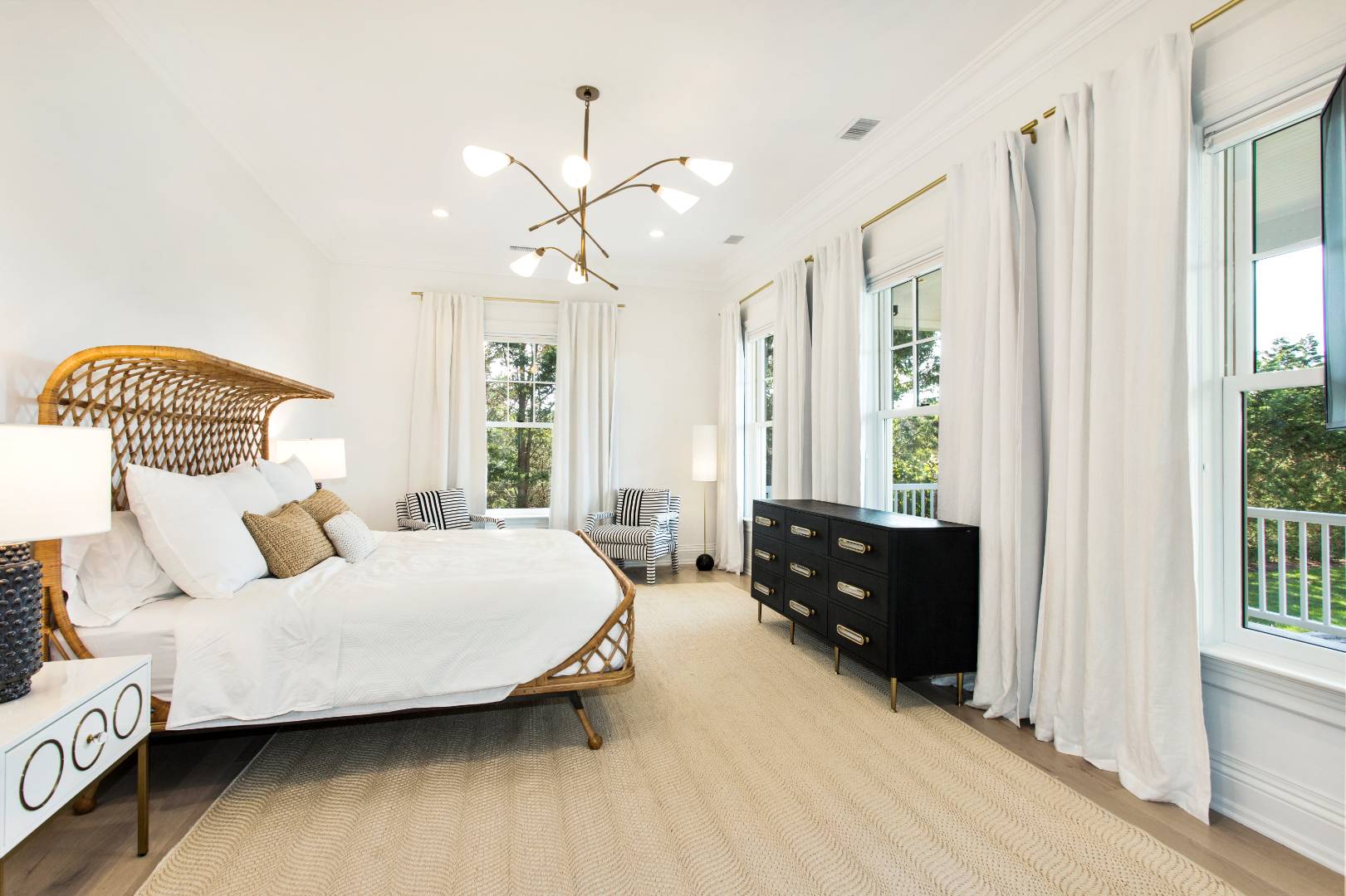 124 Dune Road Quogue, NY 11959 - Photo 31 of 34 a spacious bedroom with a bed and wooden floor