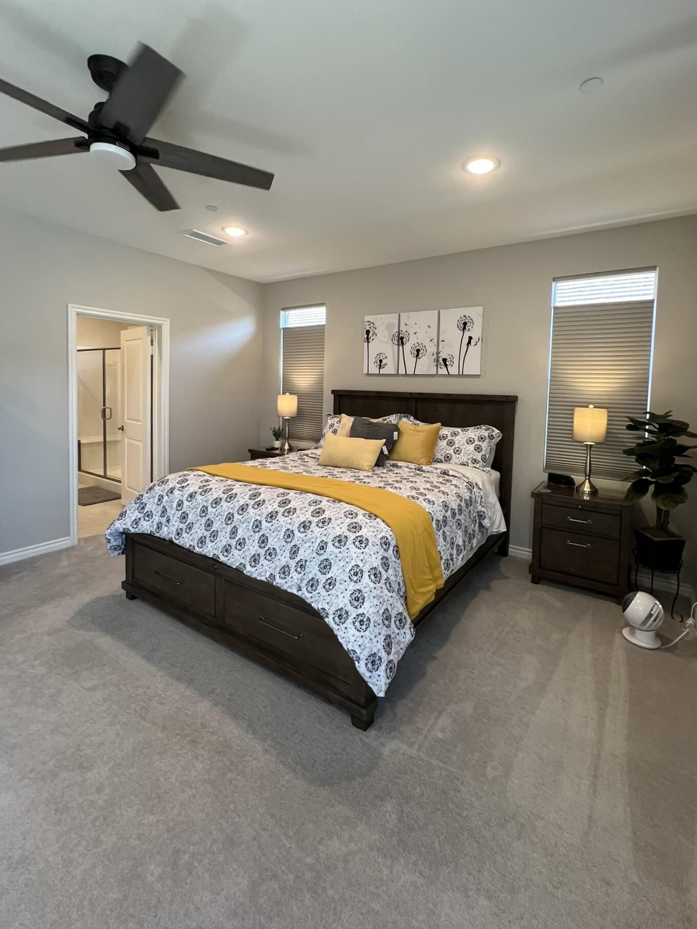 41867 Regona Road Indio, CA 92203 - Photo 13 of 65 a bedroom with a bed a lamp and a ceiling fan