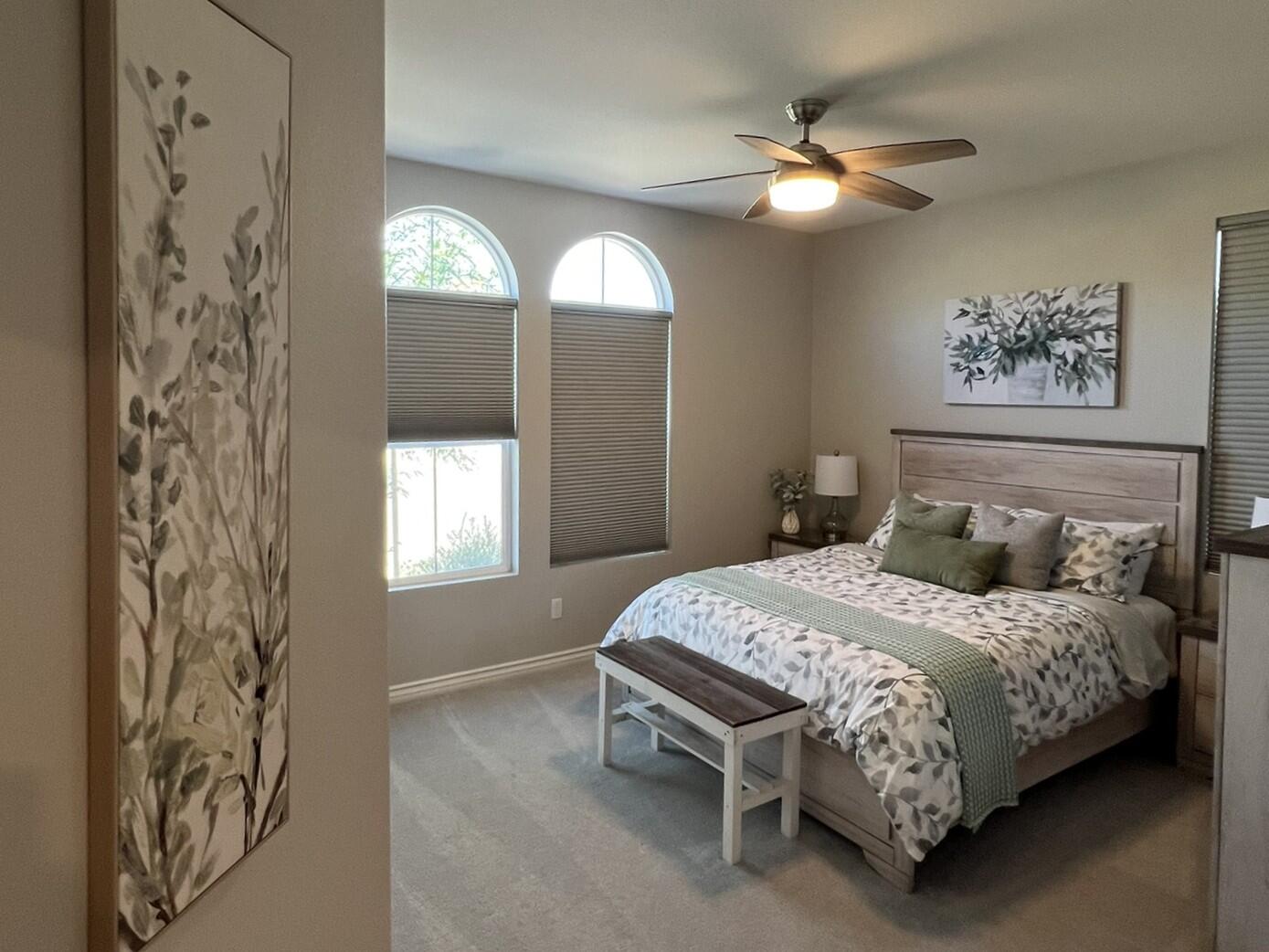 41867 Regona Road Indio, CA 92203 - Photo 24 of 65 a bedroom with a bed and a chandelier