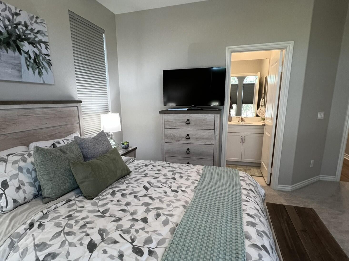 41867 Regona Road Indio, CA 92203 - Photo 26 of 65 a bedroom with a bed and flat screen tv