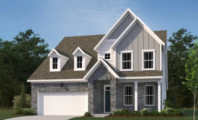 a front view of a house with plants and trees