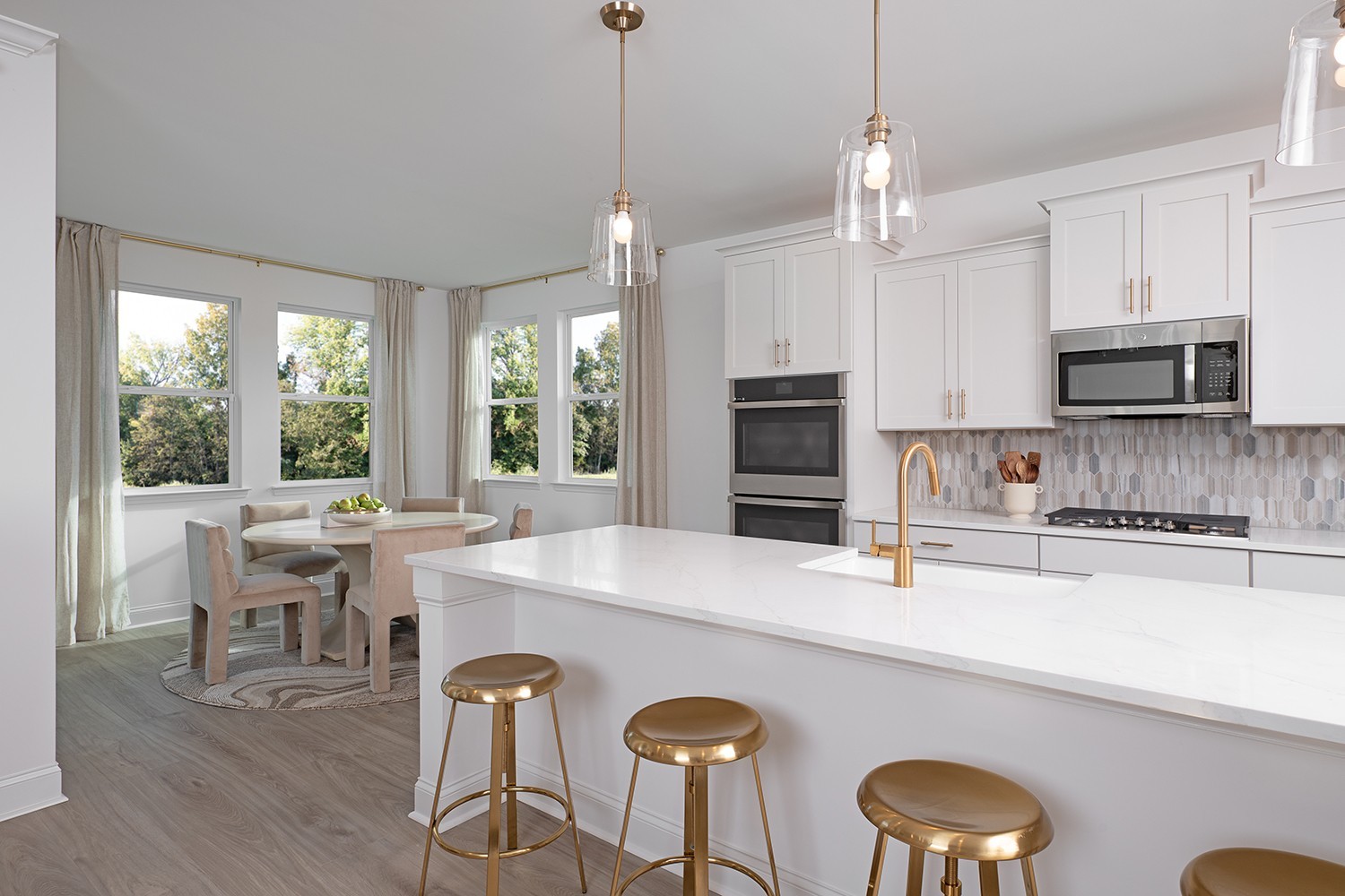 151 Emeline Way Mount Juliet, TN 37122 - Photo 7 of 51 a kitchen with stainless steel appliances granite countertop a stove a refrigerator a kitchen island a dining table and chairs