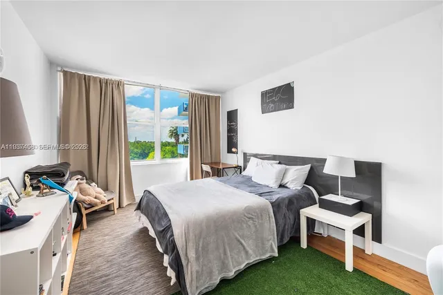 a bedroom with a bed and a couch