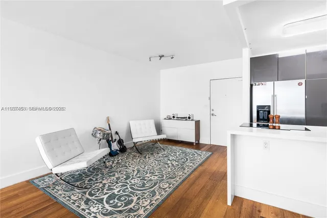 a living room with a rug and a table