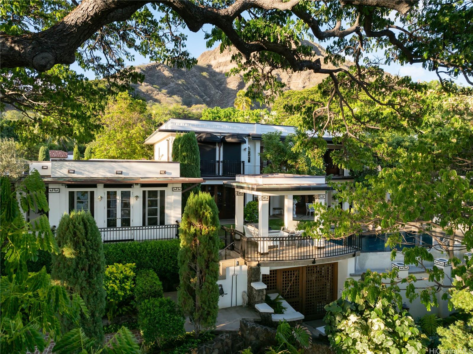 2955 Makalei Place Honolulu, HI 96815 - Photo 2 of 25 a front view of a house with a yard and potted plants